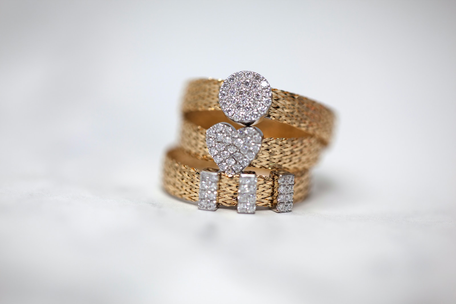 three gold-colored studded rings